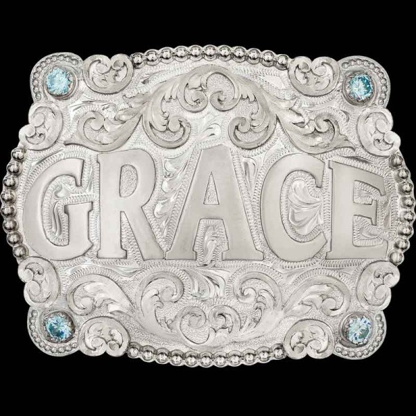 "Our Grandview Belt Buckle is nothing short of eye-catching, with immaculate details on every inch. Handcrafted on a German Silver base featuring a fine bead and scroll edge, accented with cubic zirconia stones of your choice in each corner, and hand